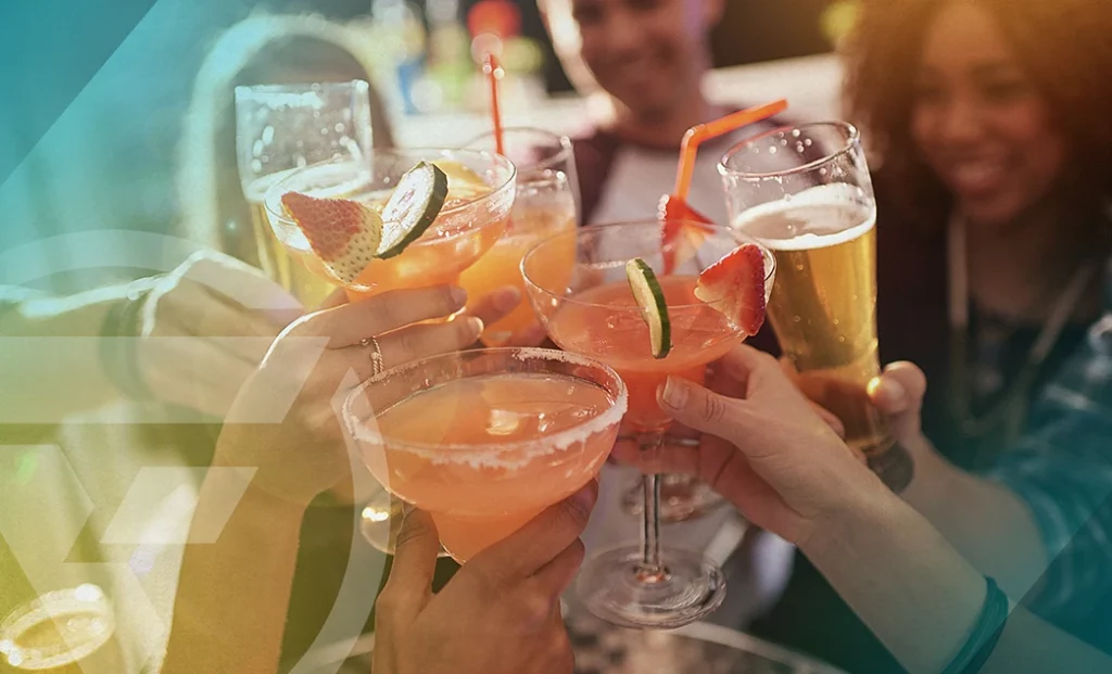 People toasting with alcoholic drinks.